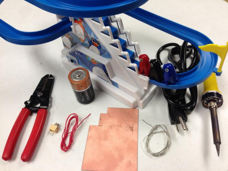 battery interrupt to control a penguin escalator toy